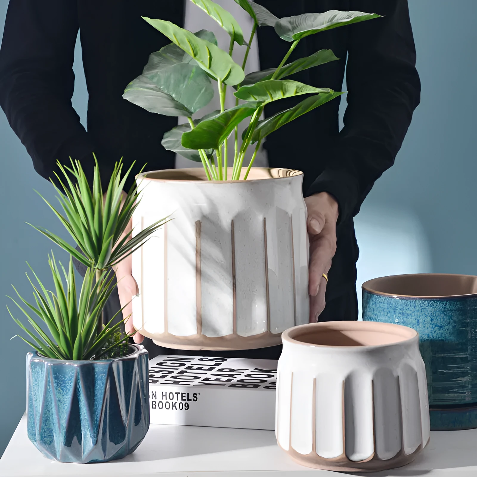 Nordic simple striped ceramic flower pot in white, 14x13cm size, on a desktop with a small plant