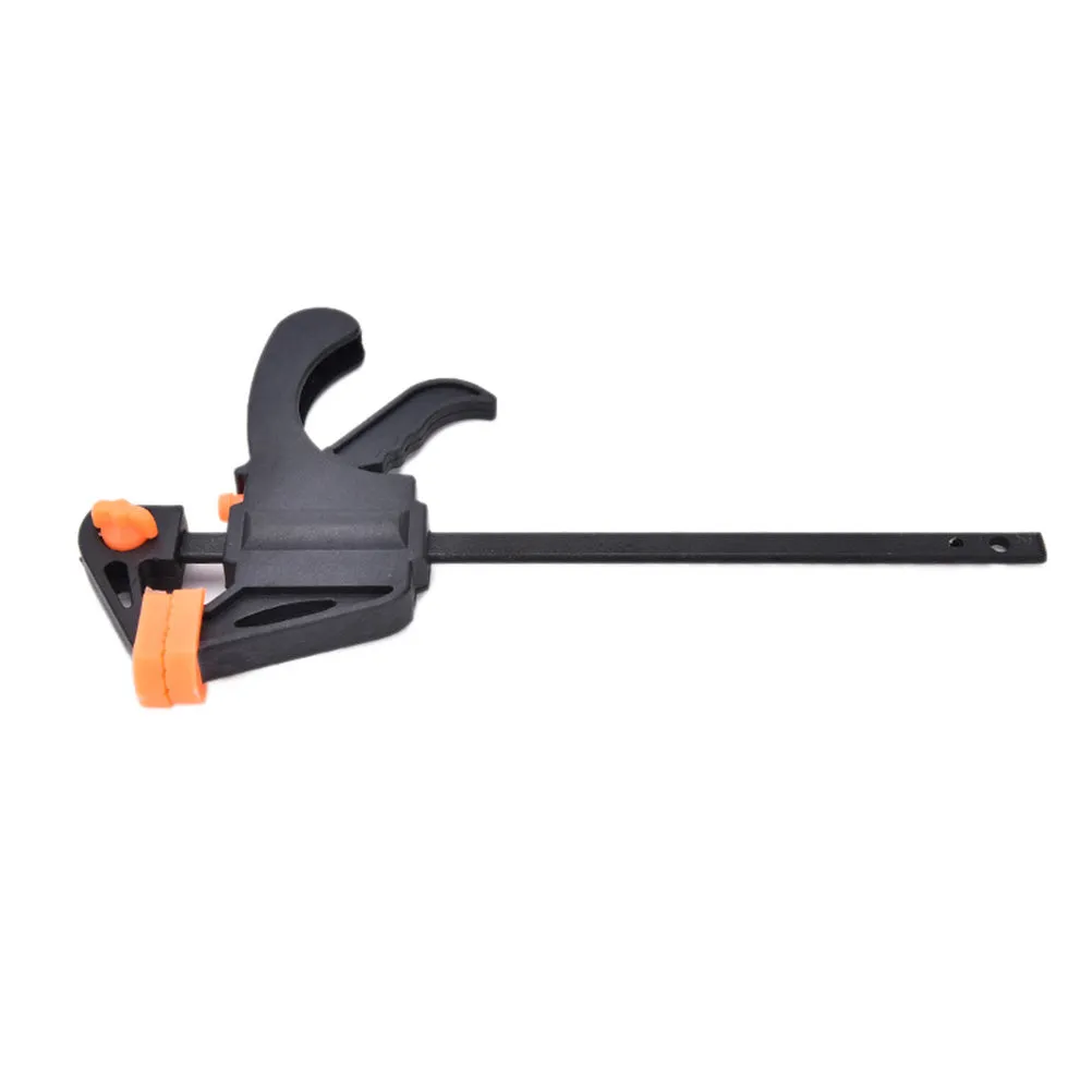 Black woodworking F clip 4 inch with plastic body and carbon steel rod on wooden board