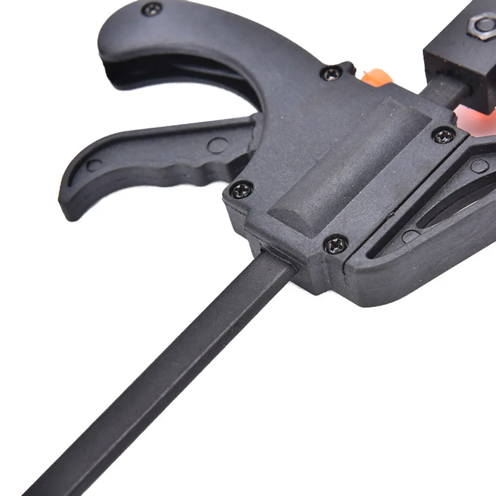 Black woodworking F clip 4 inch with plastic body and carbon steel rod on wooden board