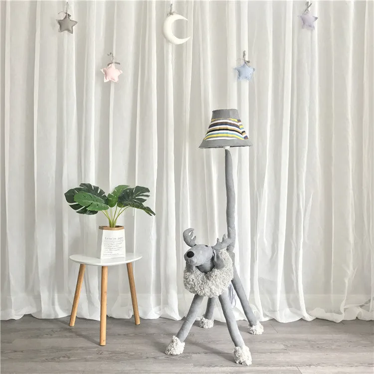 Hand-knitted cloth children's cartoon floor lamp with Christmas deer or lion design in a bedroom setting