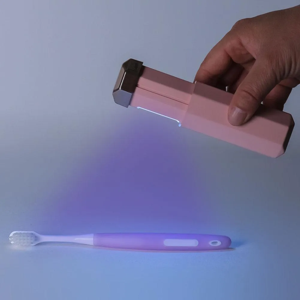 Portable UVC ozone USB germicidal wand in blue with foldable design on a table