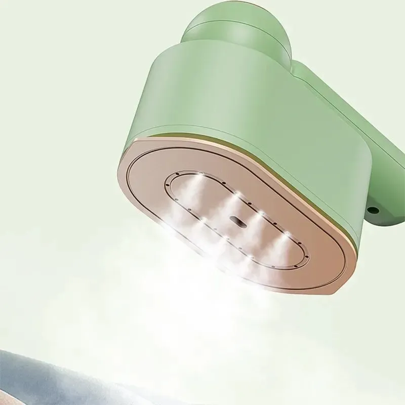 Green household 800W portable garment steamer with foldable handle and titanium plate on plain background