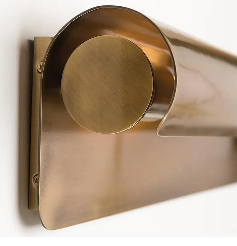 Simple modern copper wall lamp with warm light, 26cm long, on a living room wall