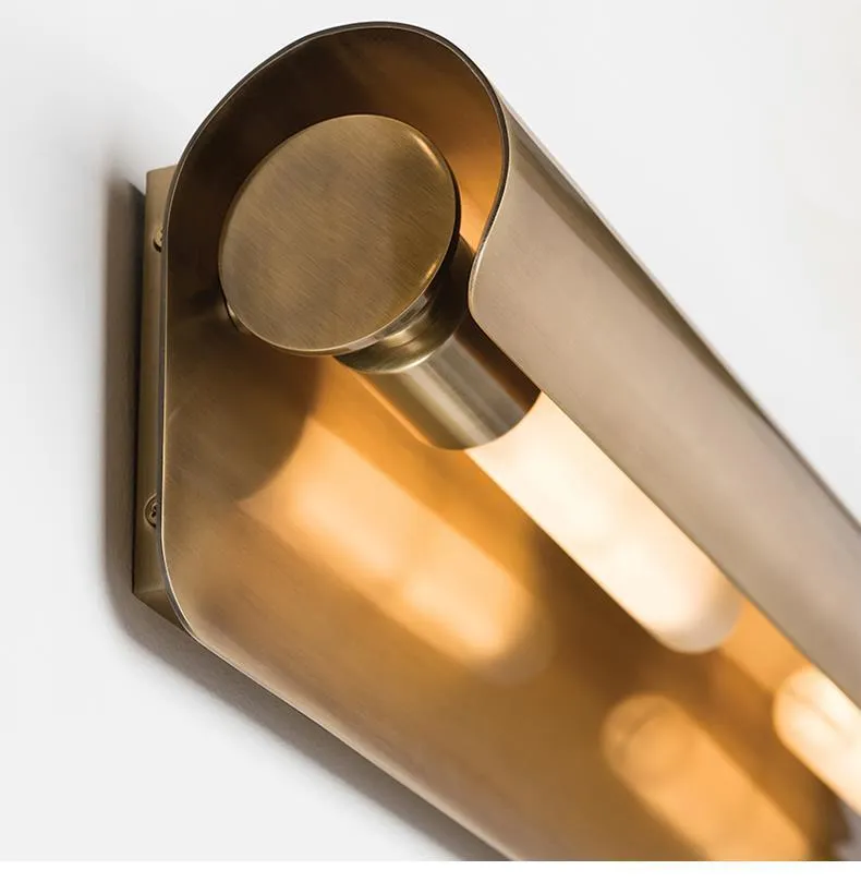 Simple modern copper wall lamp with warm light, 26cm long, on a living room wall