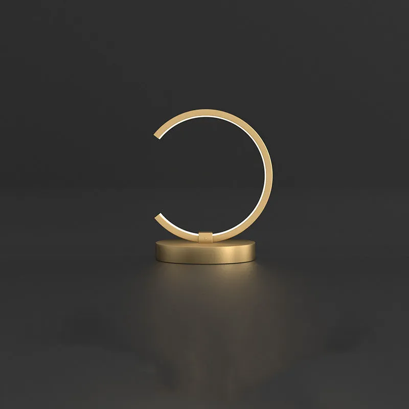 All copper Nordic style table lamp with tri-tone LED light, push button switch, on a wooden desk