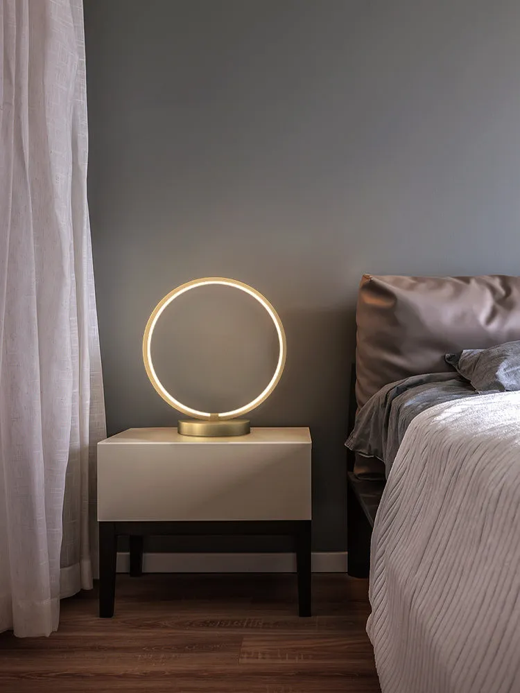All copper Nordic style table lamp with tri-tone LED light, push button switch, on a wooden desk