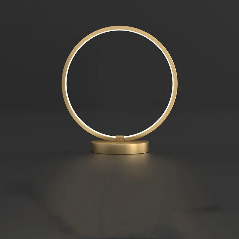 All copper Nordic style table lamp with tri-tone LED light, push button switch, on a wooden desk