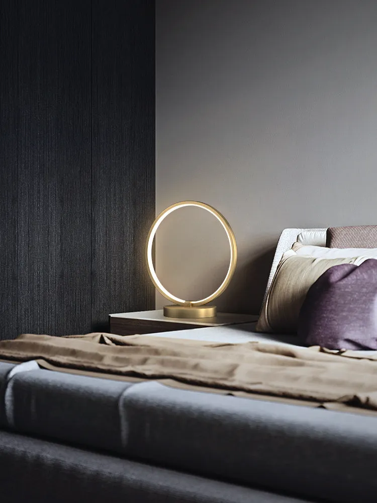 All copper Nordic style table lamp with tri-tone LED light, push button switch, on a wooden desk