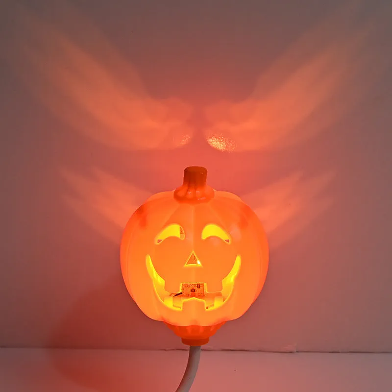 Plastic pumpkin-shaped decorative lamp with USB cable, showing yellow or purple LED light option.