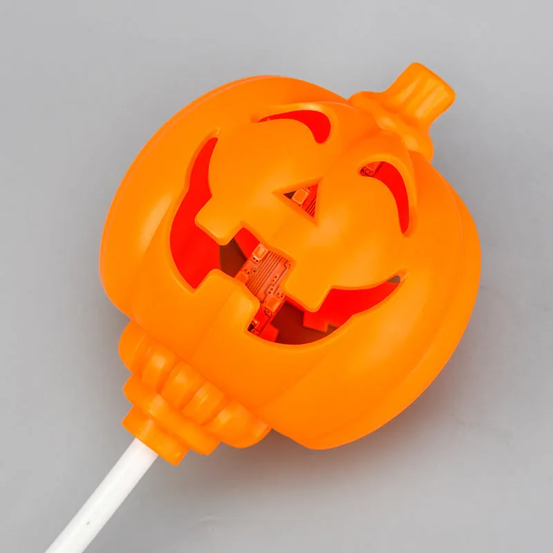 Plastic pumpkin-shaped decorative lamp with USB cable, showing yellow or purple LED light option.