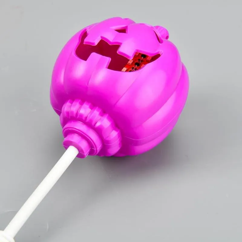 Plastic pumpkin-shaped decorative lamp with USB cable, showing yellow or purple LED light option.