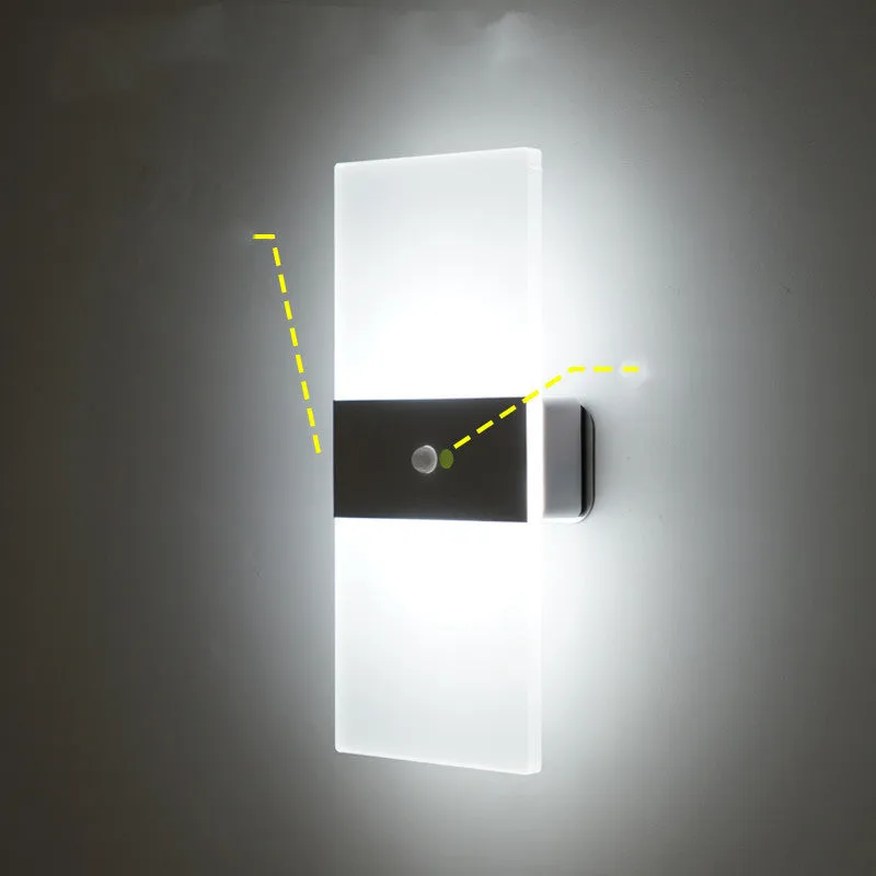 Magnetic rechargeable wall lamp in arc style, black finish, with warm light on a metal bedside shelf