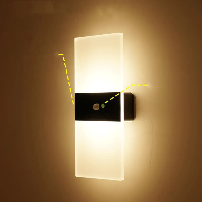 Magnetic rechargeable wall lamp in arc style, black finish, with warm light on a metal bedside shelf