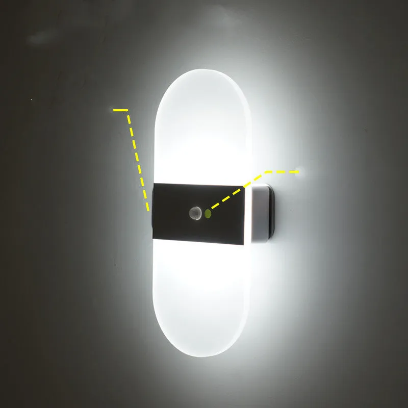 Magnetic rechargeable wall lamp in arc style, black finish, with warm light on a metal bedside shelf