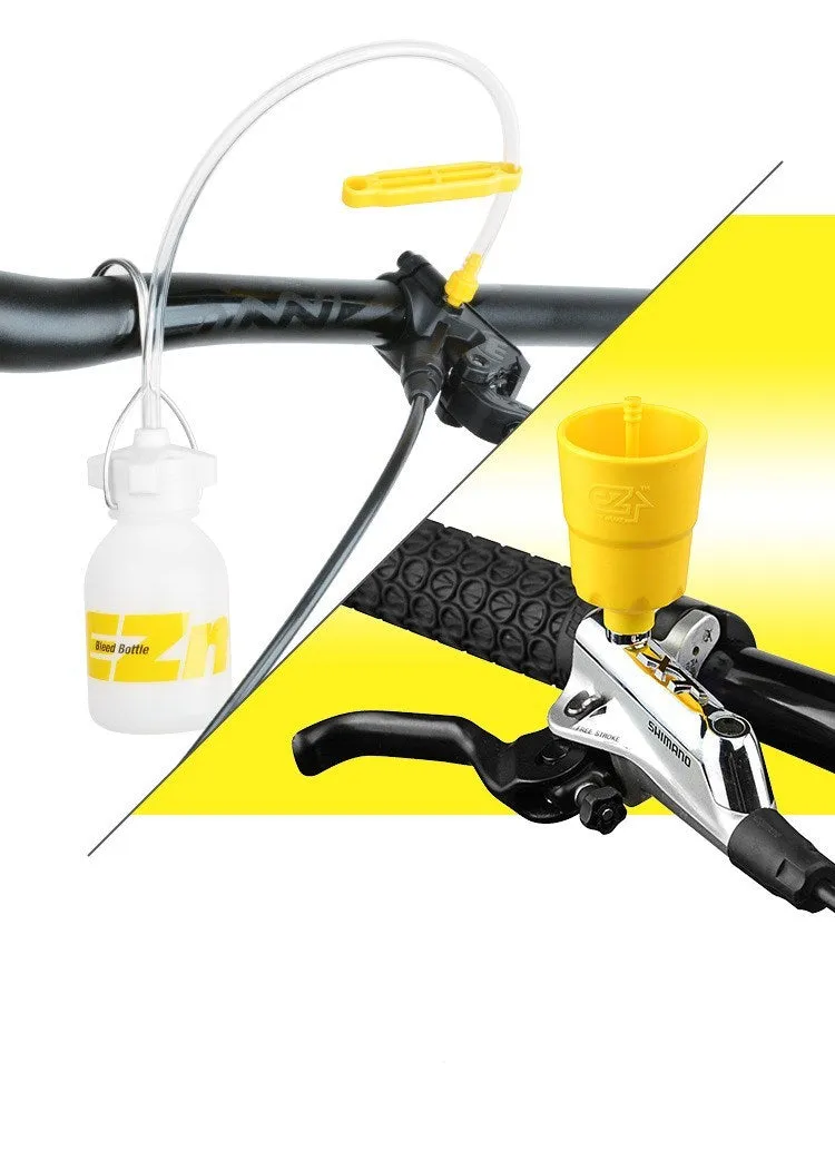 Yellow bicycle disc brake oil change bleed tool kit with metal connector on a workbench