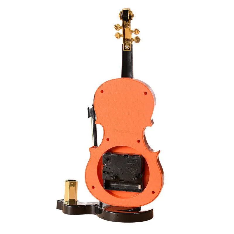 Brown violin pen inserted alarm clock with LED and pointer display on desk