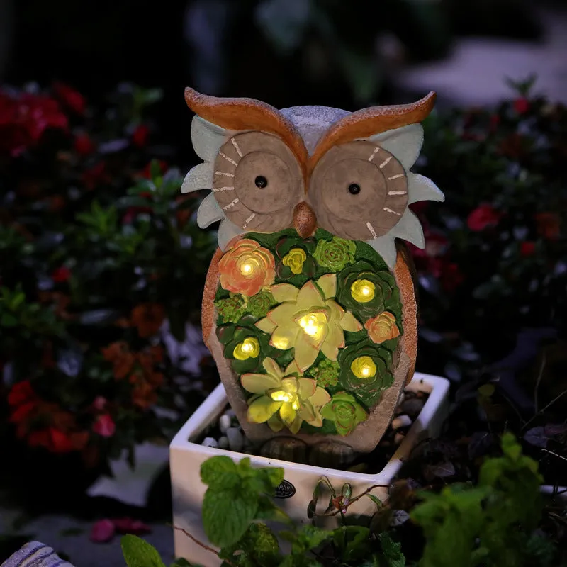 Three solar animal lights in owl, snail, and tortoise shapes on a garden window sill