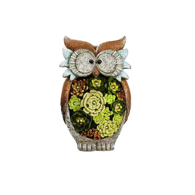 Three solar animal lights in owl, snail, and tortoise shapes on a garden window sill