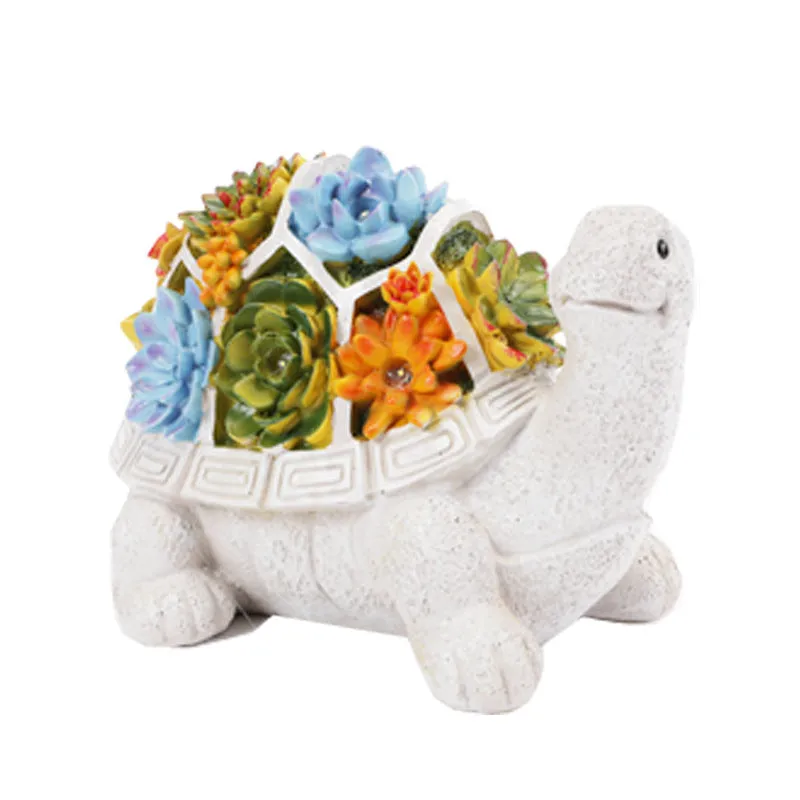 Three solar animal lights in owl, snail, and tortoise shapes on a garden window sill