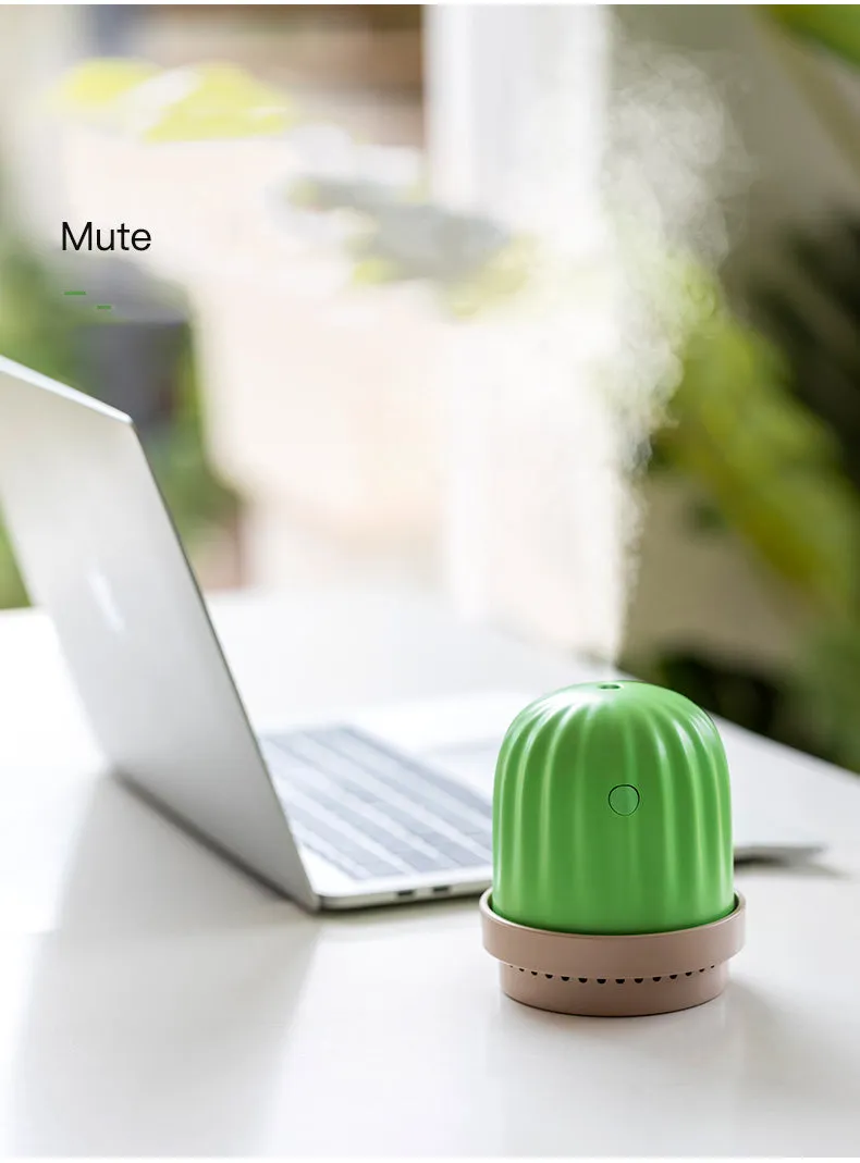 Cactus humidifier night light in green with colourful LED glow on a wooden desk