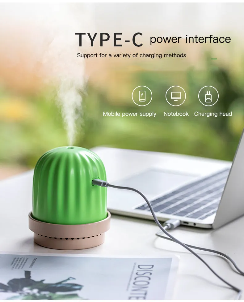 Cactus humidifier night light in green with colourful LED glow on a wooden desk