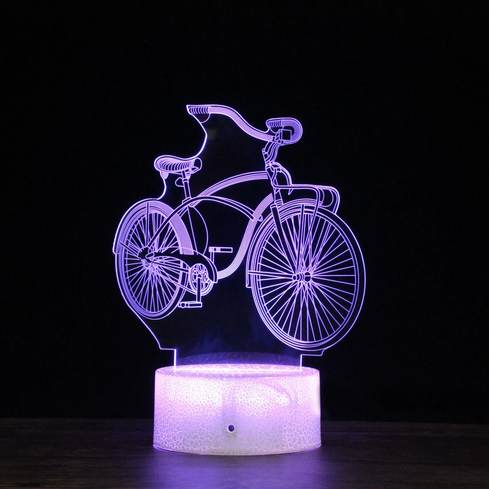 3D bicycle night light with LED acrylic shade on black base against a dark background