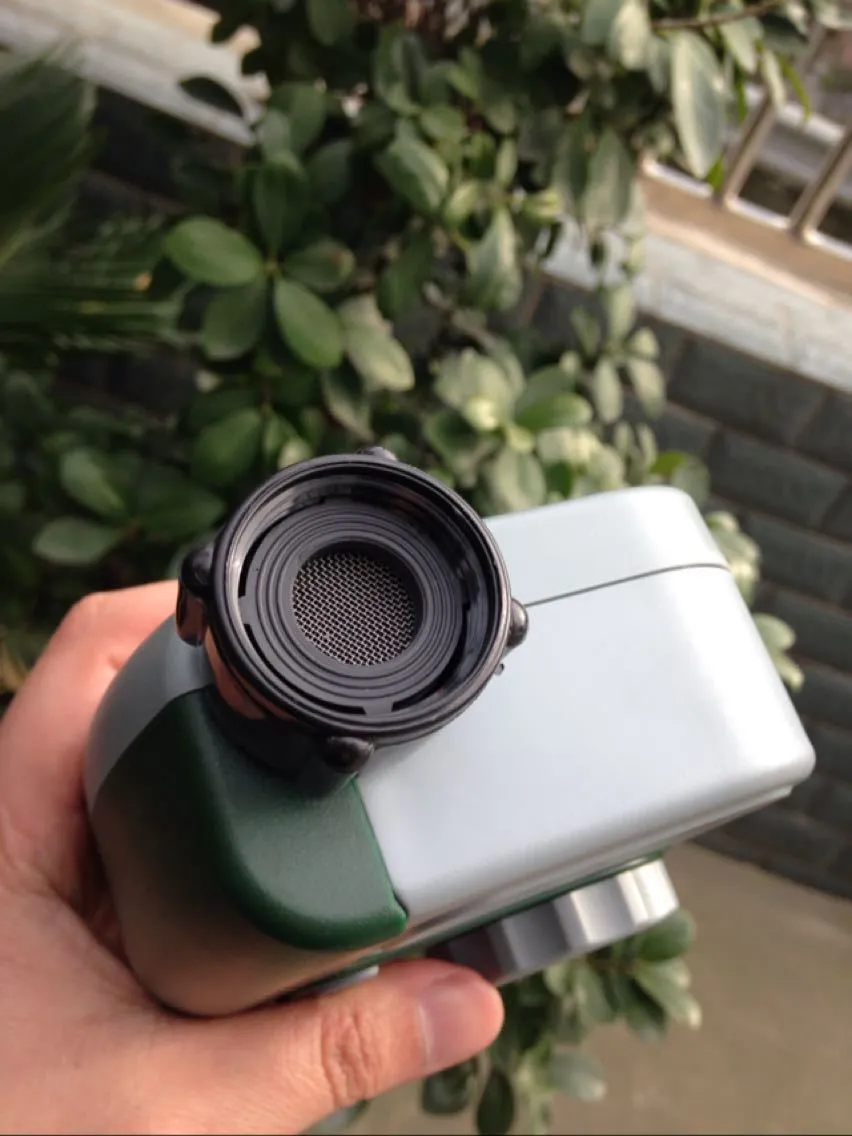 Green digital programmable hose timer with metal faucet connector and dual outlet ports for garden watering