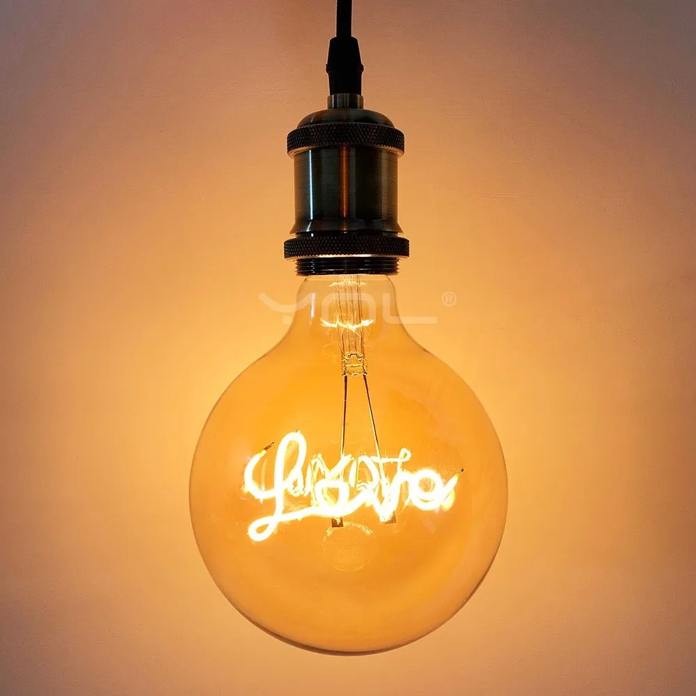 Yellow LOVE letter lamp with glass lampshade emitting warm light, 125x175mm on a tabletop