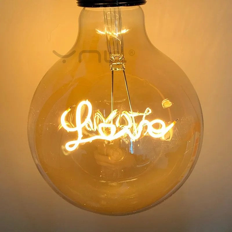 Yellow LOVE letter lamp with glass lampshade emitting warm light, 125x175mm on a tabletop