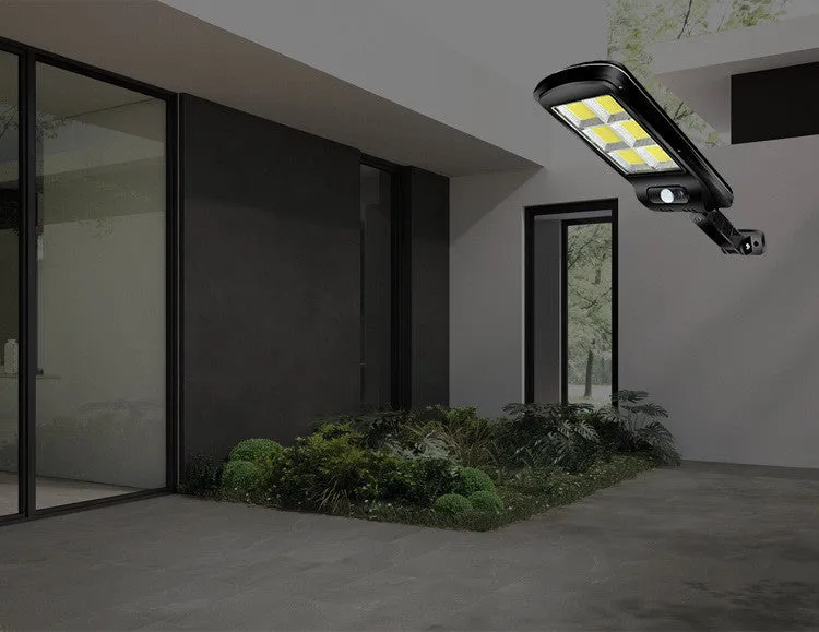 Black solar-powered outdoor motion sensor light with IP65 waterproof rating for garden and driveway security.