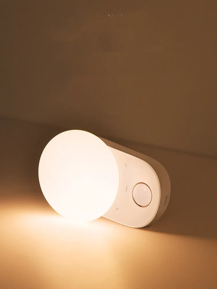 White Baseus Sunshine Series rechargeable LED night light with motion sensor on a bedside table.