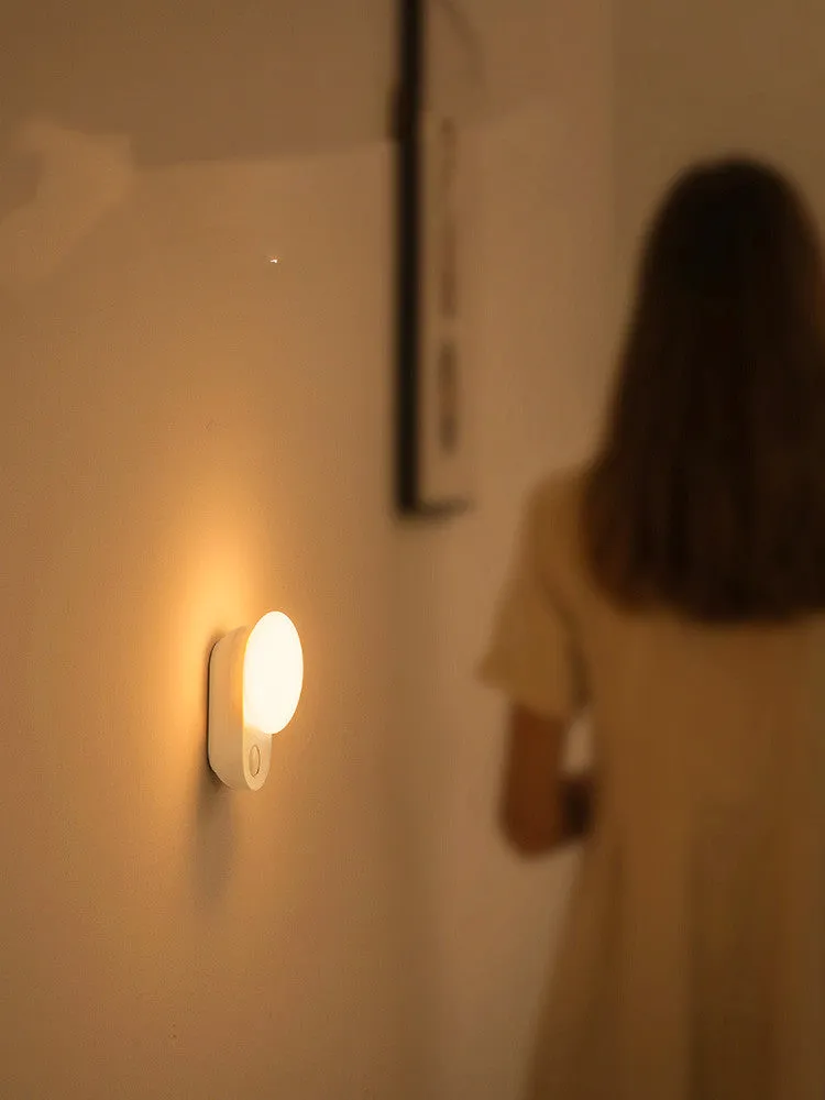 White Baseus Sunshine Series rechargeable LED night light with motion sensor on a bedside table.