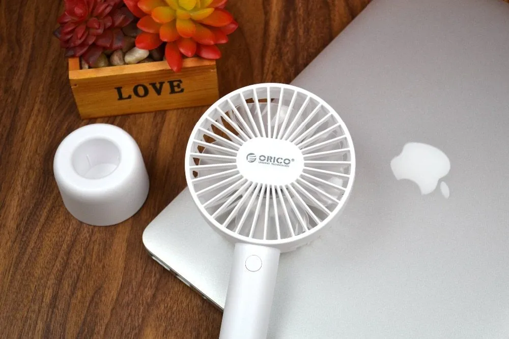 White ORICO FH1 portable USB rechargeable desk fan with three-speed buttons and compact handheld design.