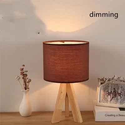Japanese style solid wood table lamp with fabric lampshade in linen trumpet colour on bedside table