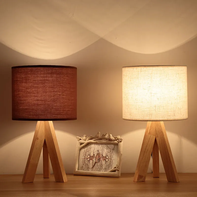 Japanese style solid wood table lamp with fabric lampshade in linen trumpet colour on bedside table