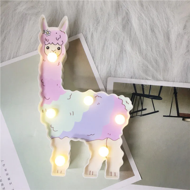 Alpaca night light 19cm tall in white colour on bedside table