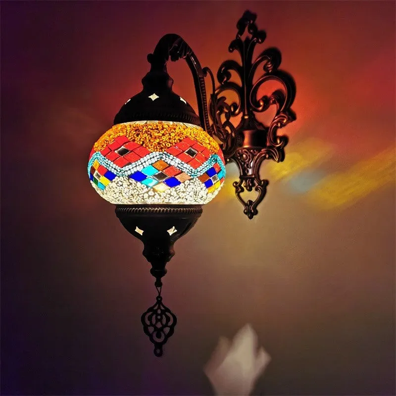 Bohemian iron wall lamp with bronze electroplated finish and primary colour glass shade, measuring 14cm diameter and 40cm height