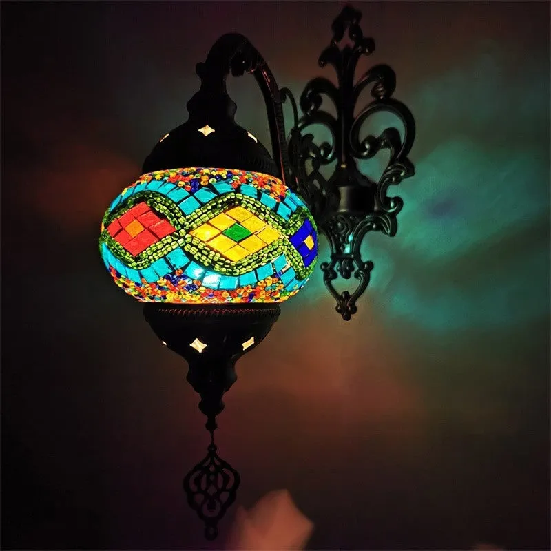 Bohemian iron wall lamp with bronze electroplated finish and primary colour glass shade, measuring 14cm diameter and 40cm height