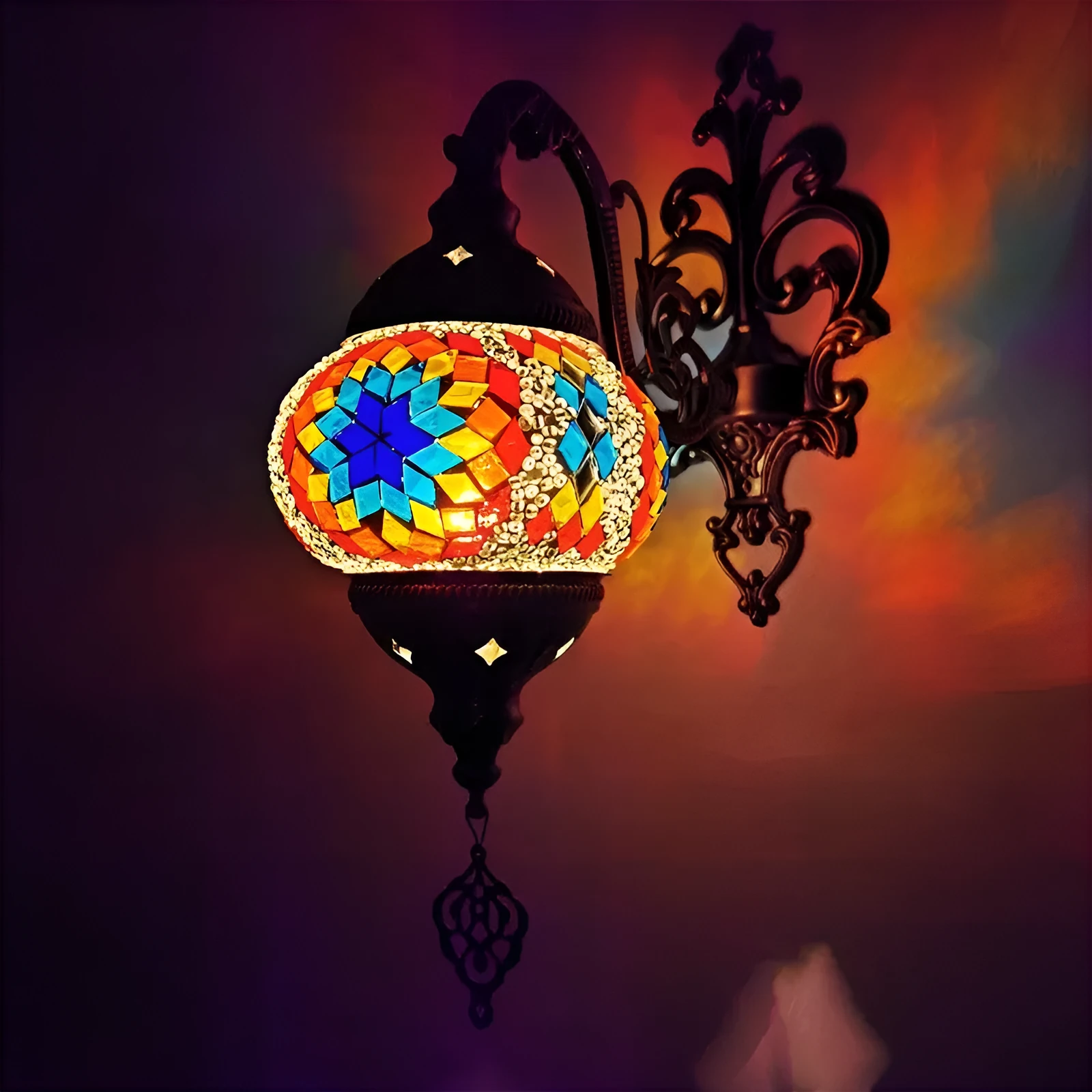 Bohemian iron wall lamp with bronze electroplated finish and primary colour glass shade, measuring 14cm diameter and 40cm height