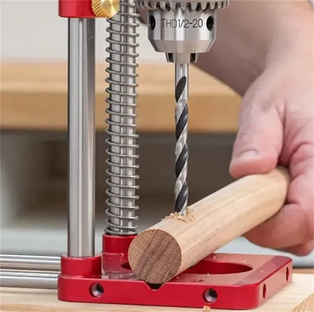 Red alloy steel woodworking drill locator on wood surface with plastic components