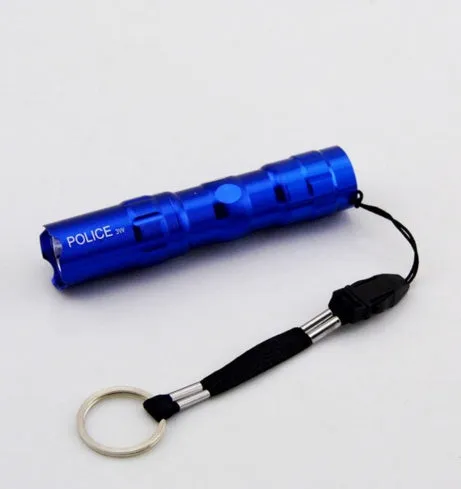 Black aluminium mini LED flashlight showing scale next to a AA battery.