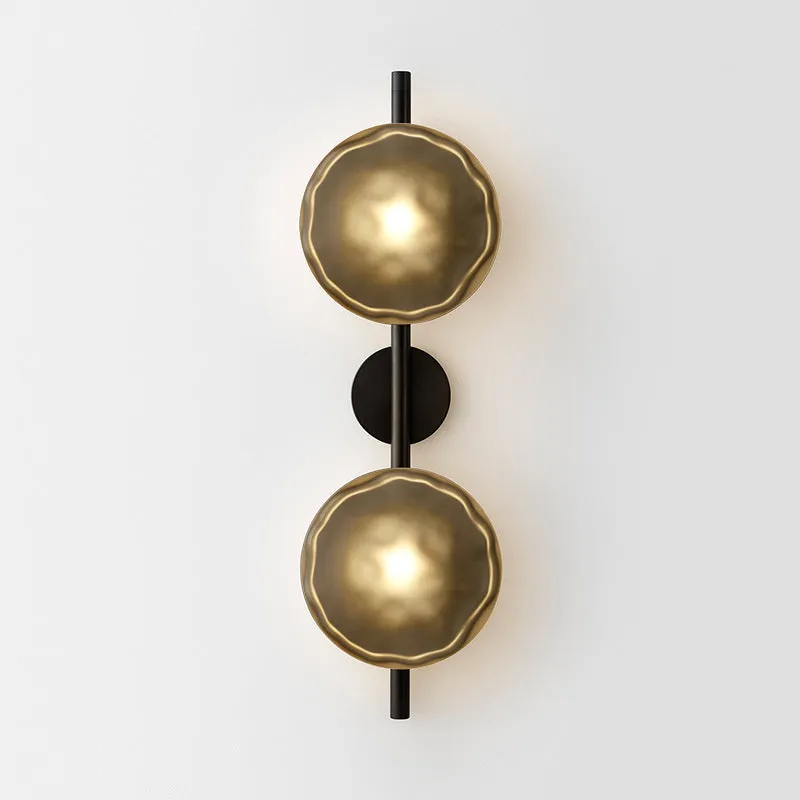 Bedside hotel glass art wall lamp with transparent lampshade and iron body on a wall