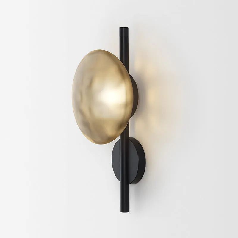 Bedside hotel glass art wall lamp with transparent lampshade and iron body on a wall