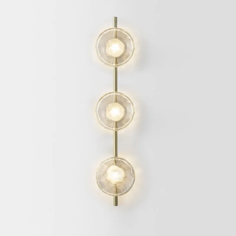 Bedside hotel glass art wall lamp with transparent lampshade and iron body on a wall