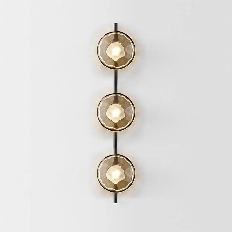 Bedside hotel glass art wall lamp with transparent lampshade and iron body on a wall