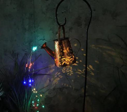 Iron solar garden lamp with tapered butterfly pattern and warm white LED light.