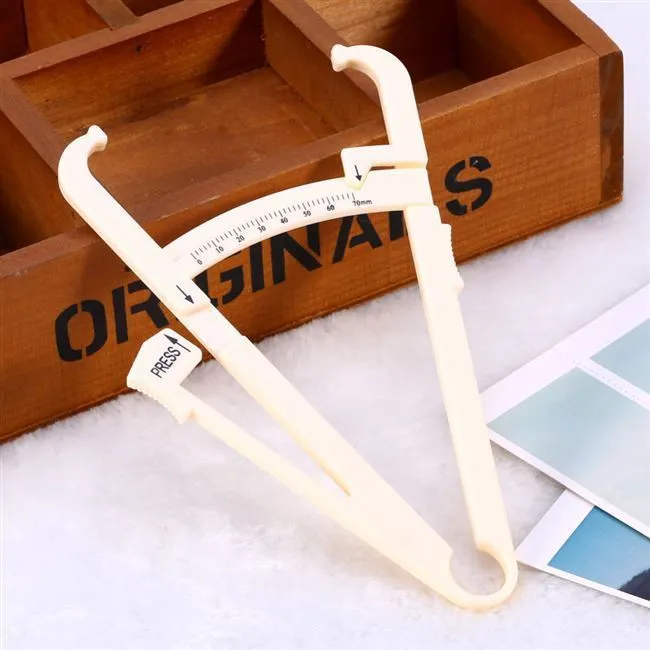 Compact acrylic fat caliper for body fat measurement, showing size and scale.