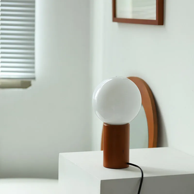 Retro bamboo and glass cylinder table lamp with button switch and USB port on bedside table