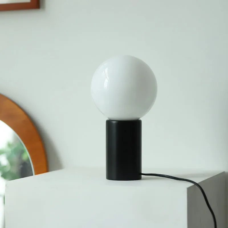 Retro bamboo and glass cylinder table lamp with button switch and USB port on bedside table