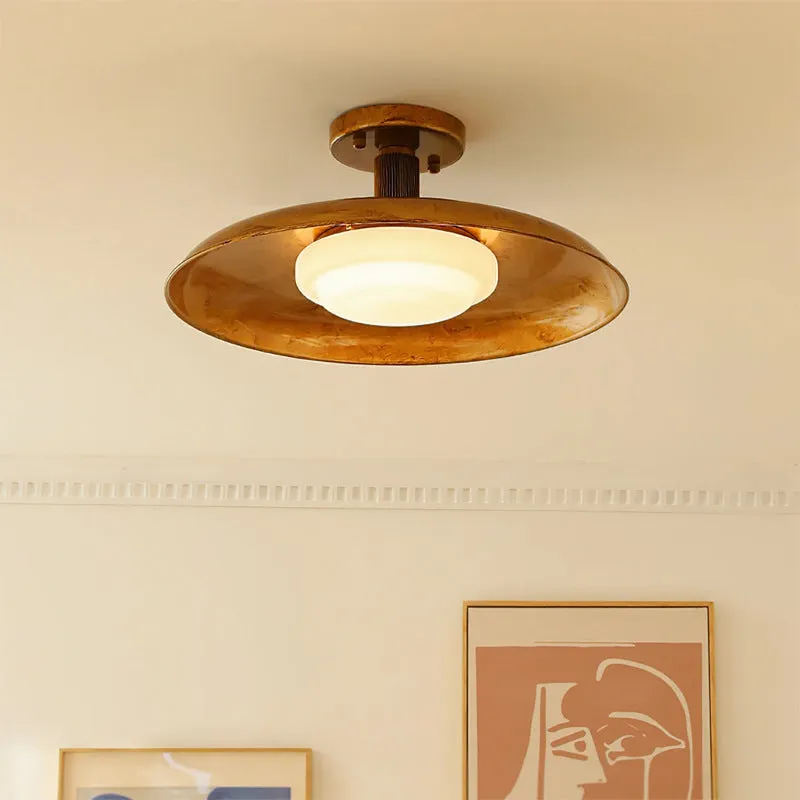 American retro alloy ceiling lamp in copper finish mounted on a ceiling.